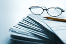 Stack of papers with yellow pencil on top