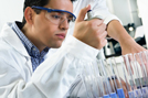 Technician Viewing Laboratory Beaker