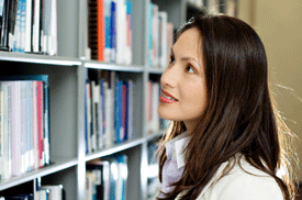 Businesswoman looking for book